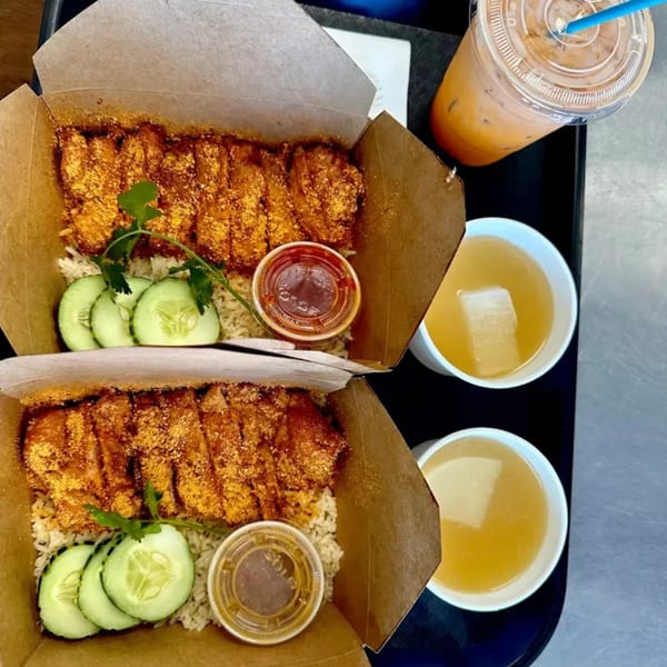 Two takeout boxes of Hen's crispy Thai chicken and rice, with soup and iced tea.